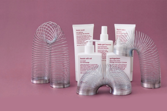 the evo curl range of products on a purple backdrop with some metal springs
